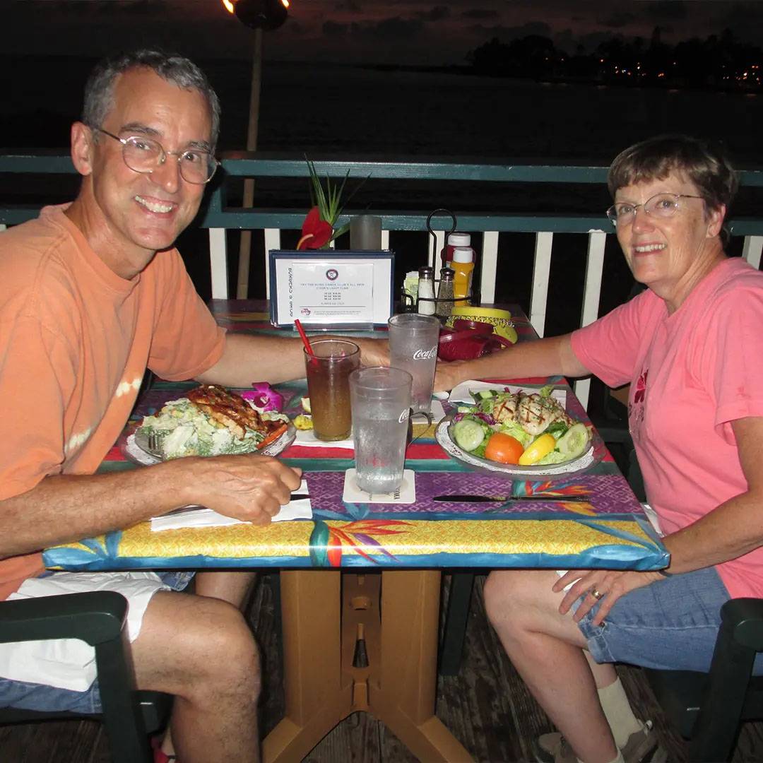 Photo of couple smiling while eating dinner