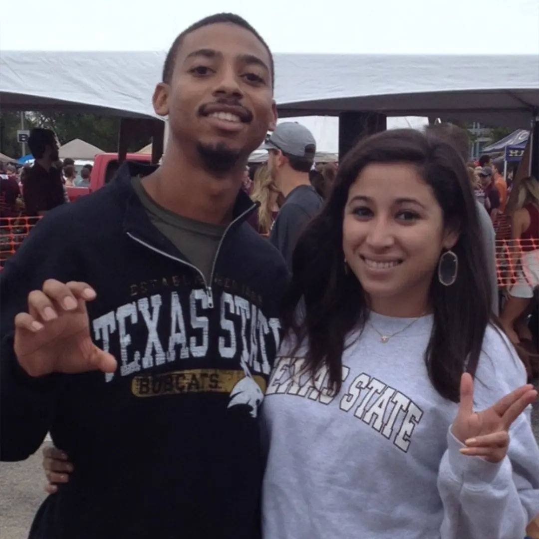 photo of couple smiling at TXST tailgate event