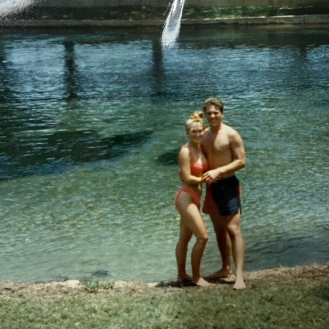 photo of couple standing together at a river