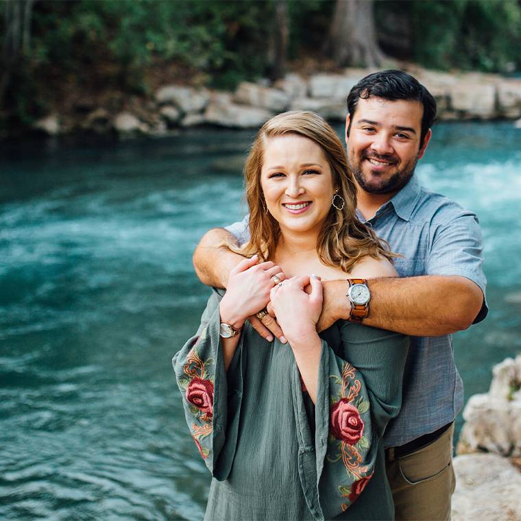 photo of couple holding each other against a pool