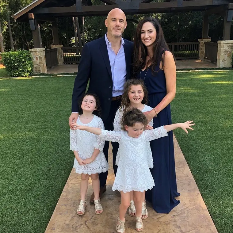 group photo of family with three children wearing matching white dresses