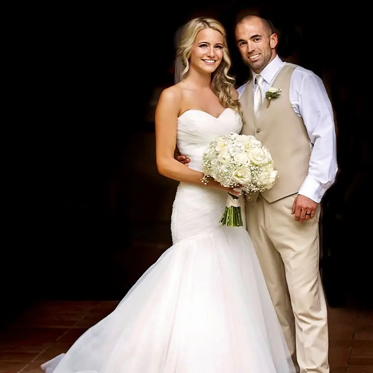 photo of couple at their wedding against a dark background