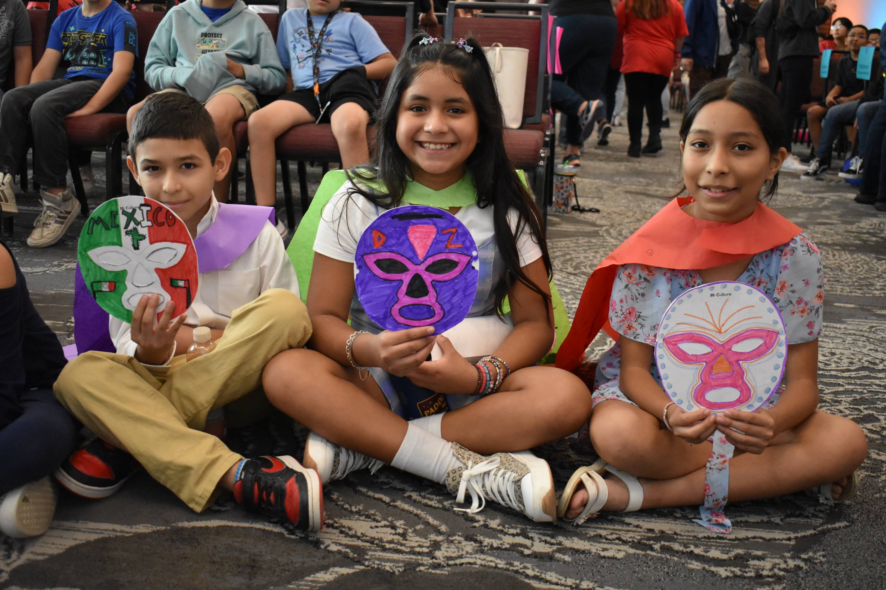 Children holding luchador masks