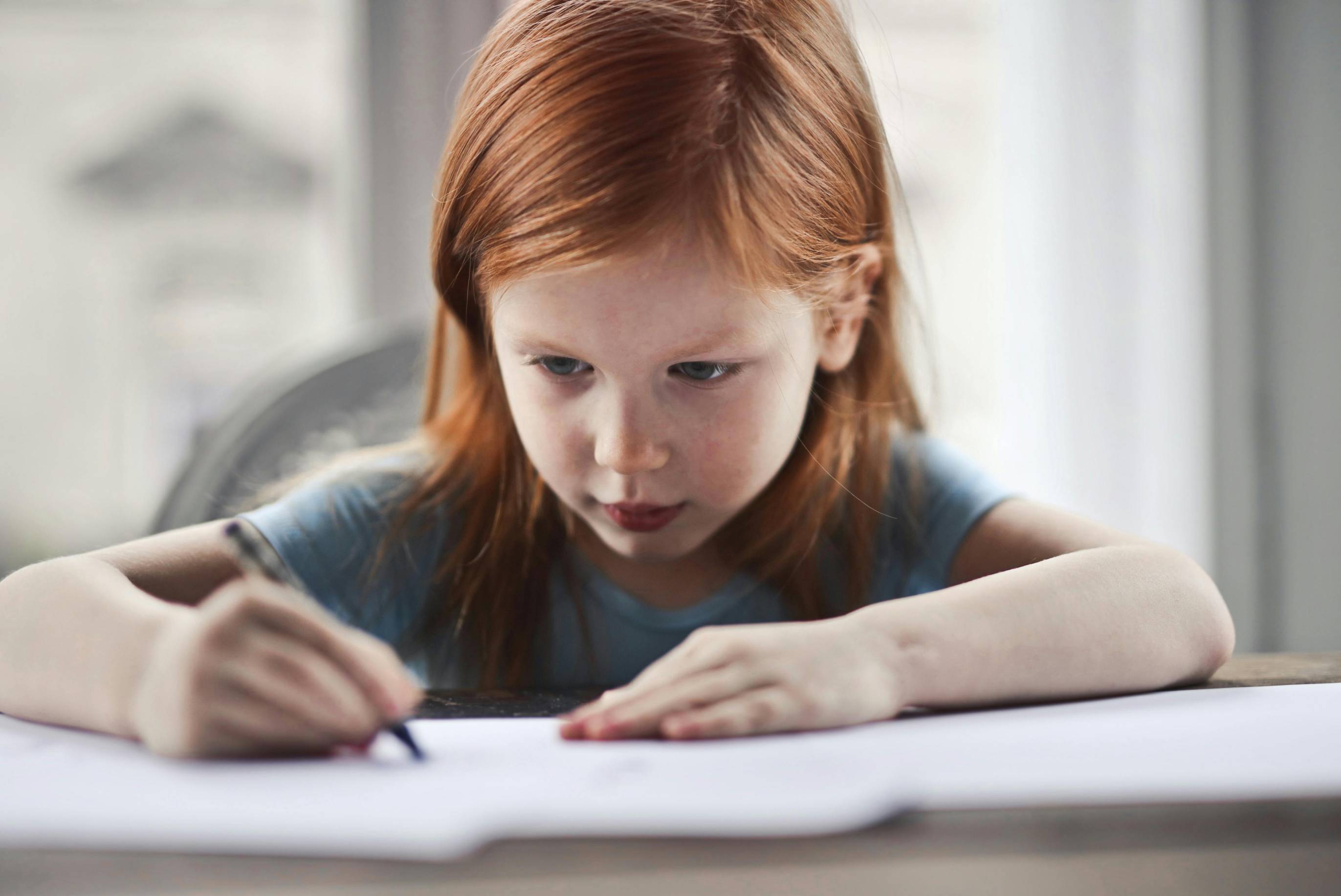 Child Writing on Paper