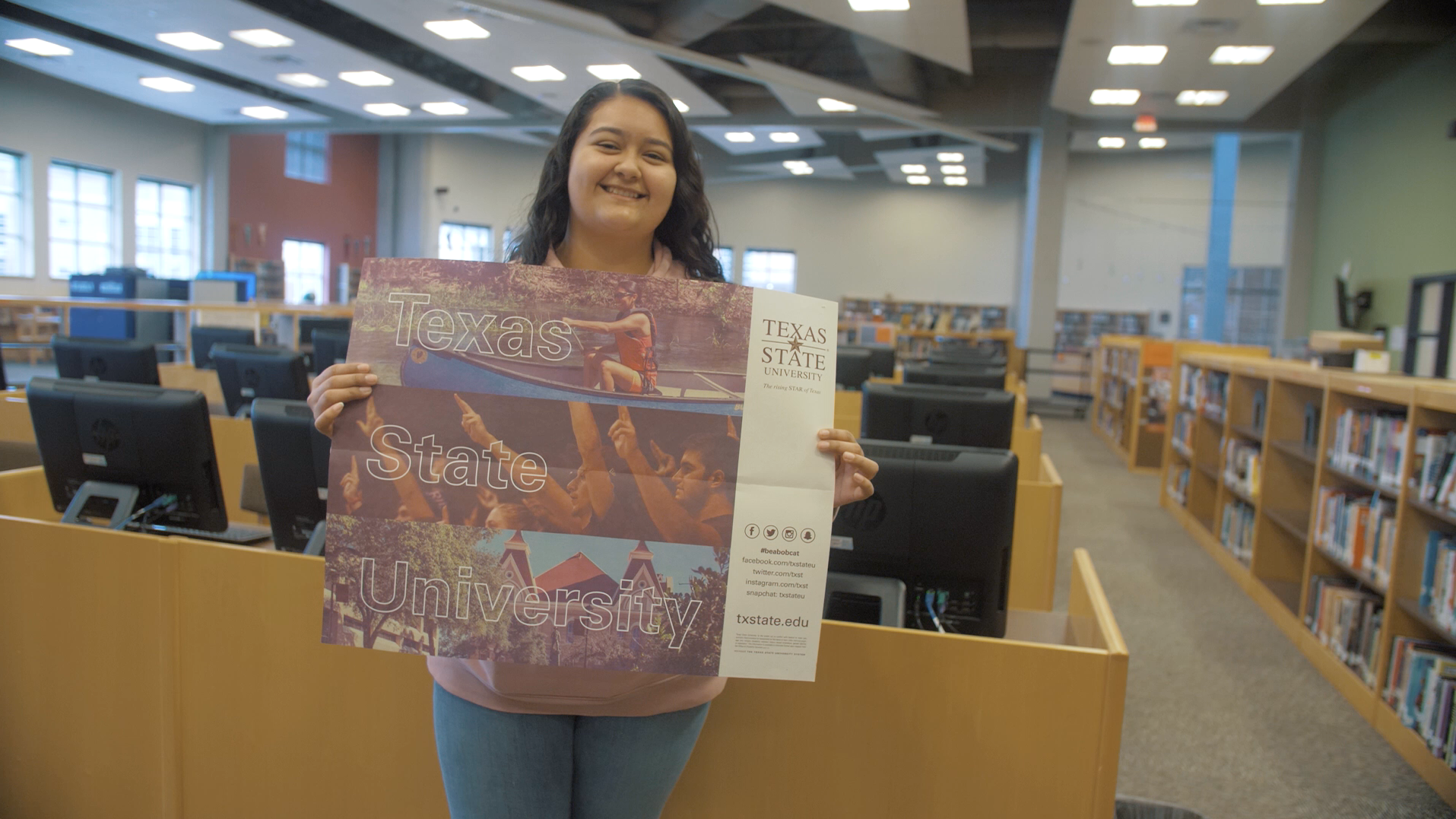Student holding Texas State sign
