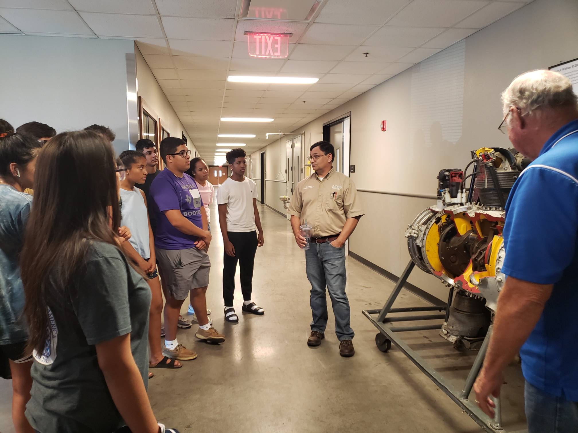 Teacher discussing engine project with students