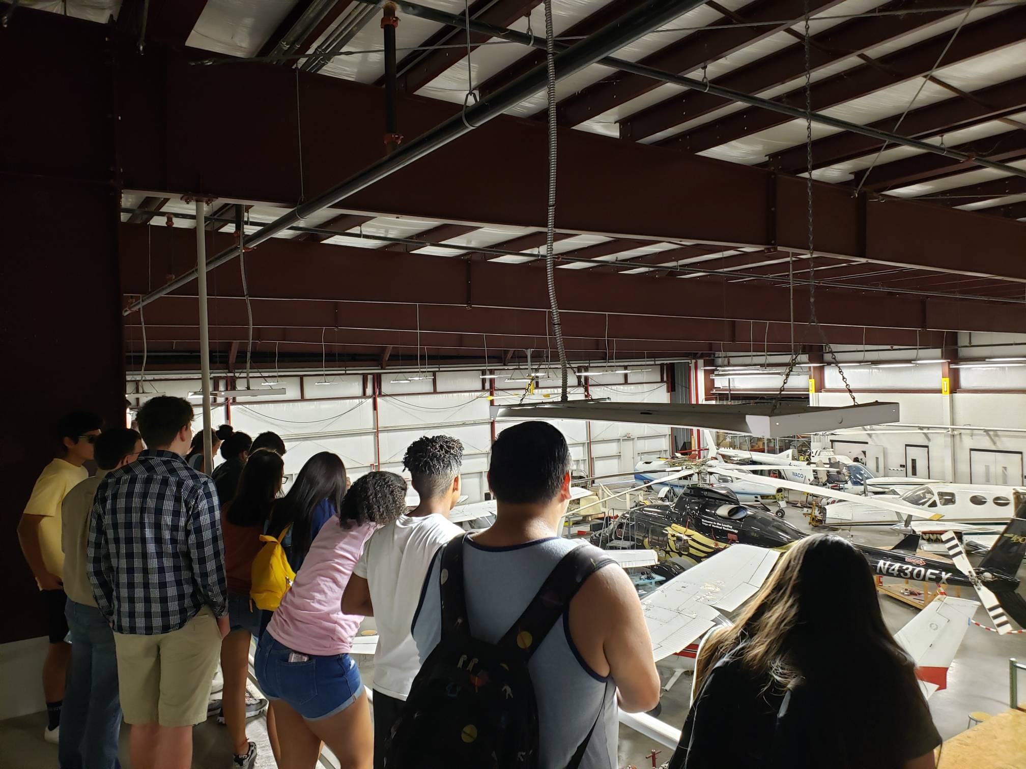students on a field trip to a airport hanger