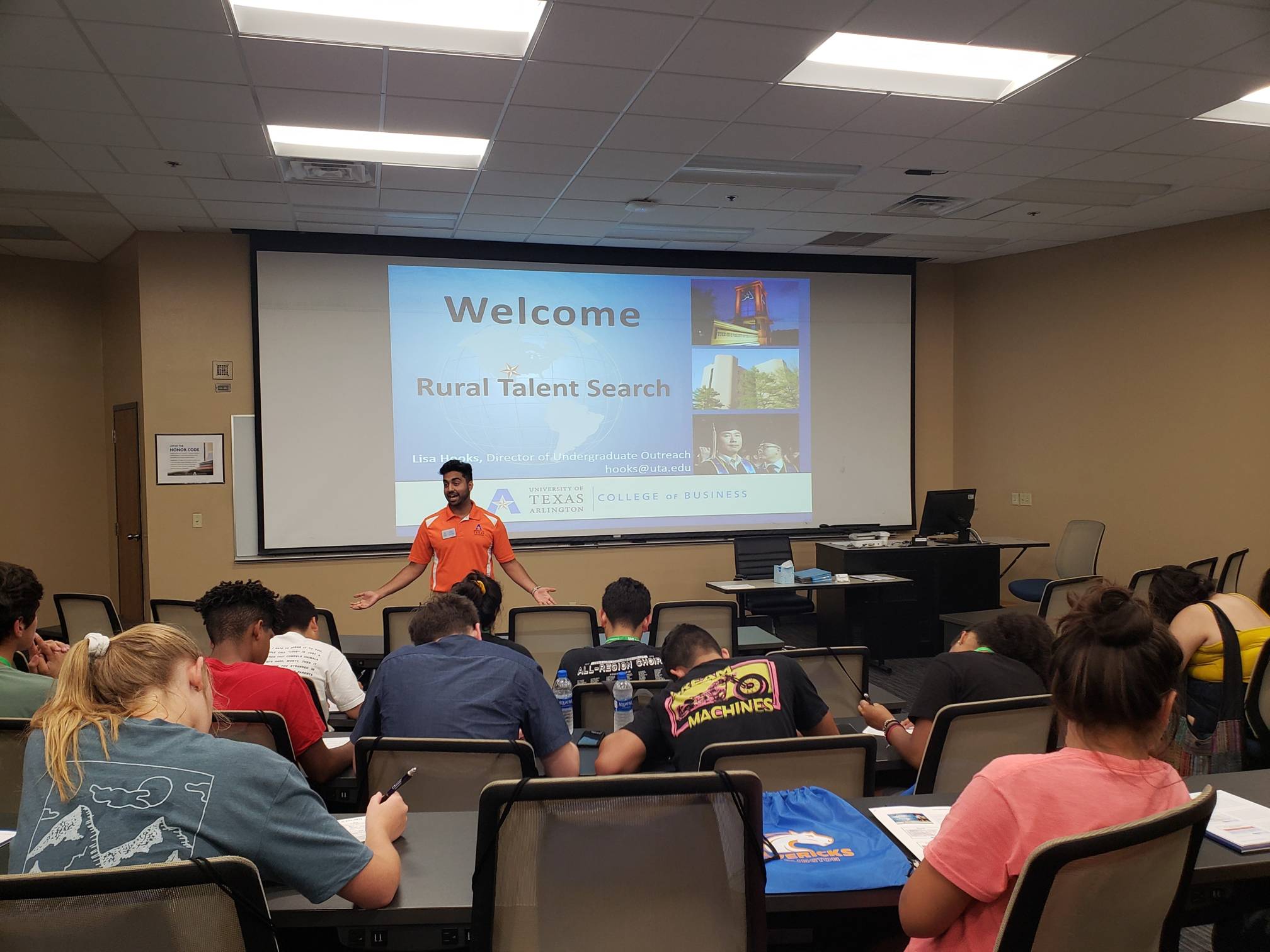 Talent search staff member discussing services to participants