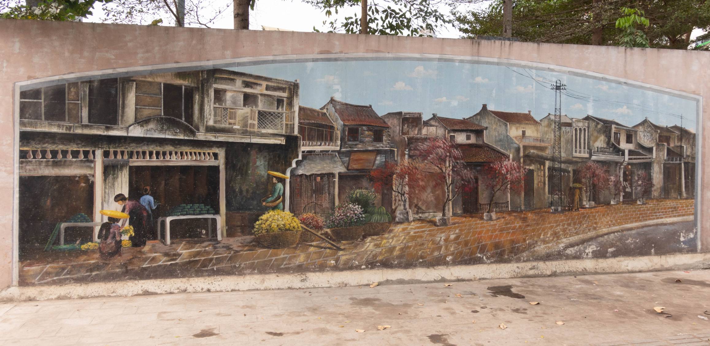 mural on wall of a row of houses. On the left there are people doing something but it is unclear what they are doing.