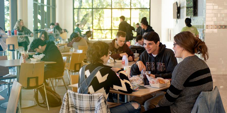 students at a table eating in Jones Dining Center