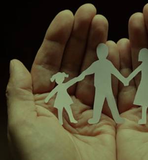 human hands holding family cutout