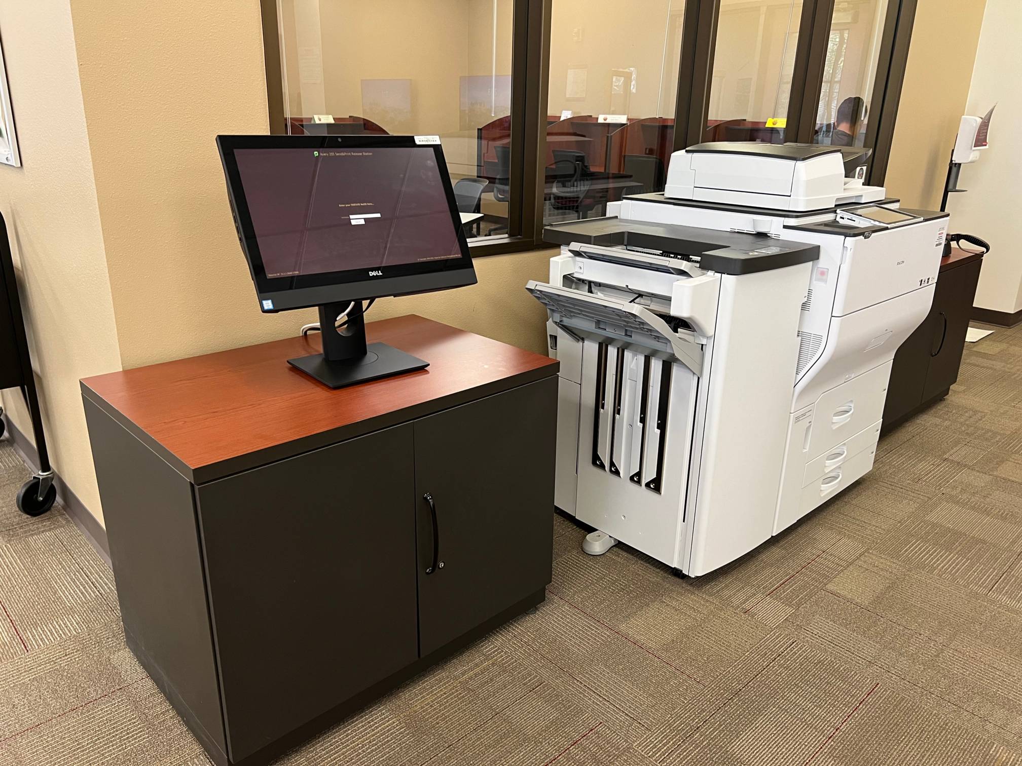 a printer and scanner with a computer beside them