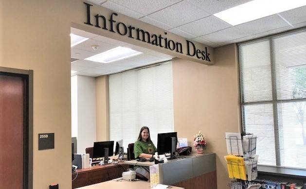 an information desk with a student worker