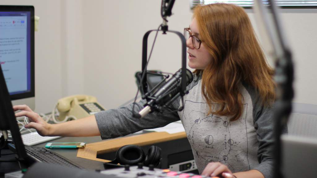 Student in front of audio controls