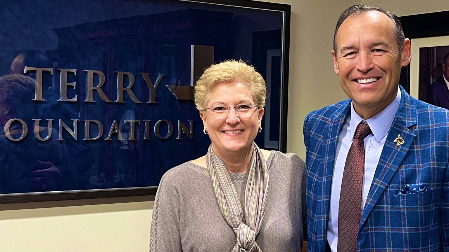 President Damphousse, right, poses for a photo with Yvonne Moody in front of the Terry Foundation sign.
