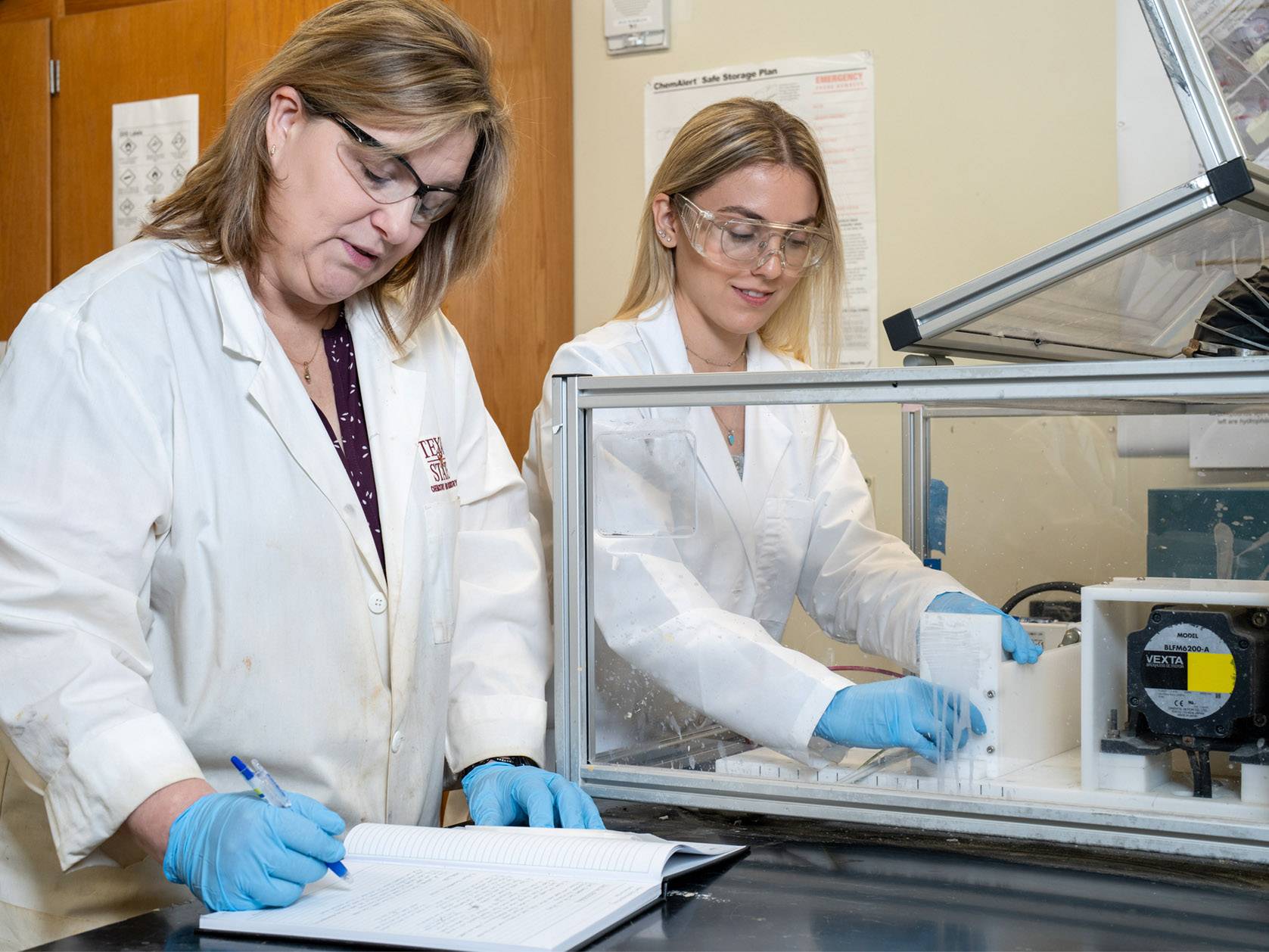 two women in lab setting conducting experiment