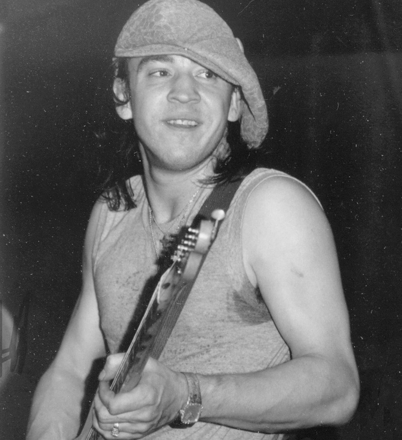 black and white photo of stevie ray vaughn playing guitar