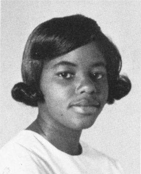 A monochromic photo of Shirley Harris, the first Black student to graduate from Texas State University in 1967. She appears very youthful with a slight smile on her lips as she stares at the camera. 