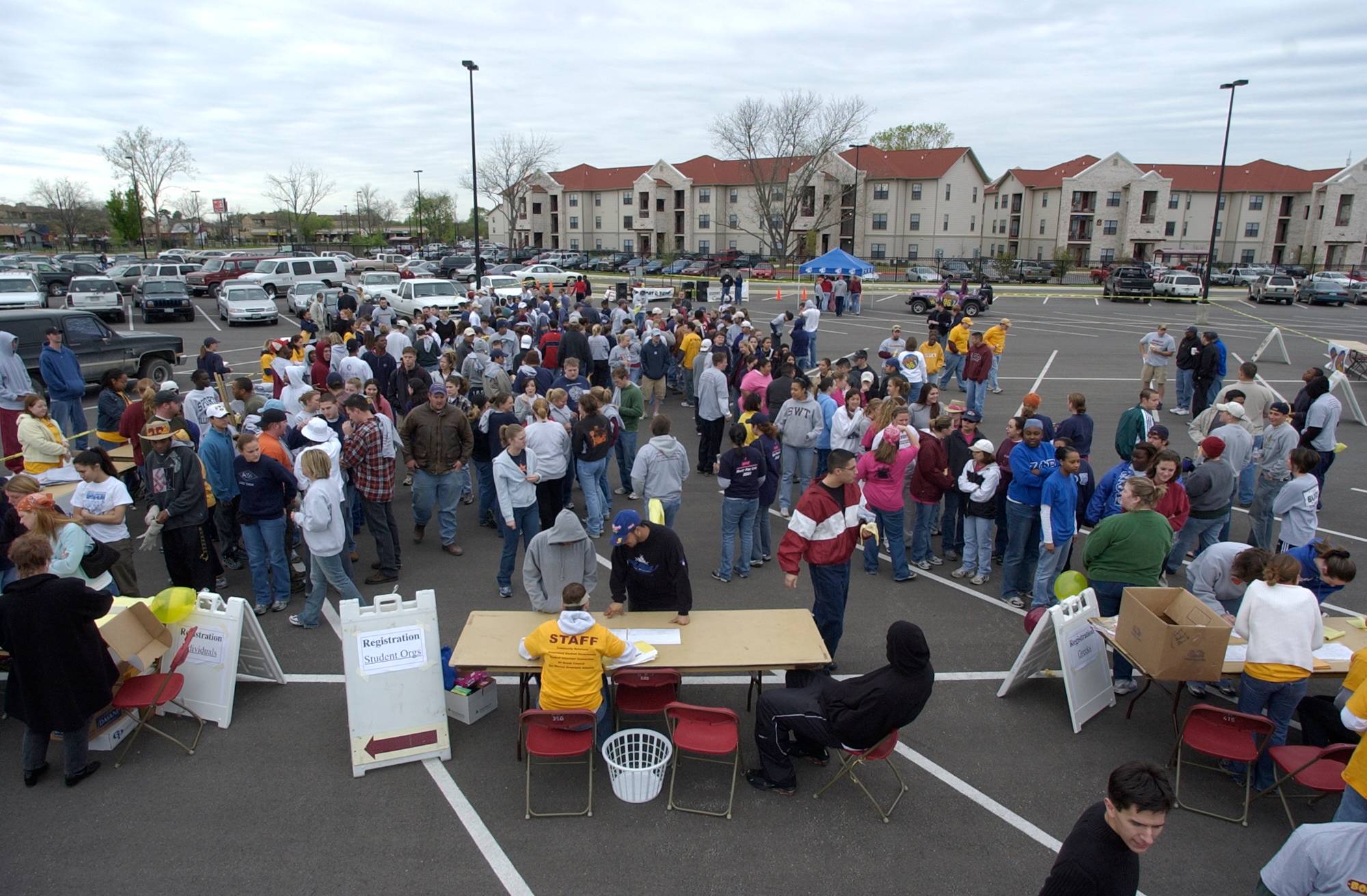 Volunteers for Bobcat Build gathering in the Bobcat Village parking lot, waiting to be sent out on their assignments. 