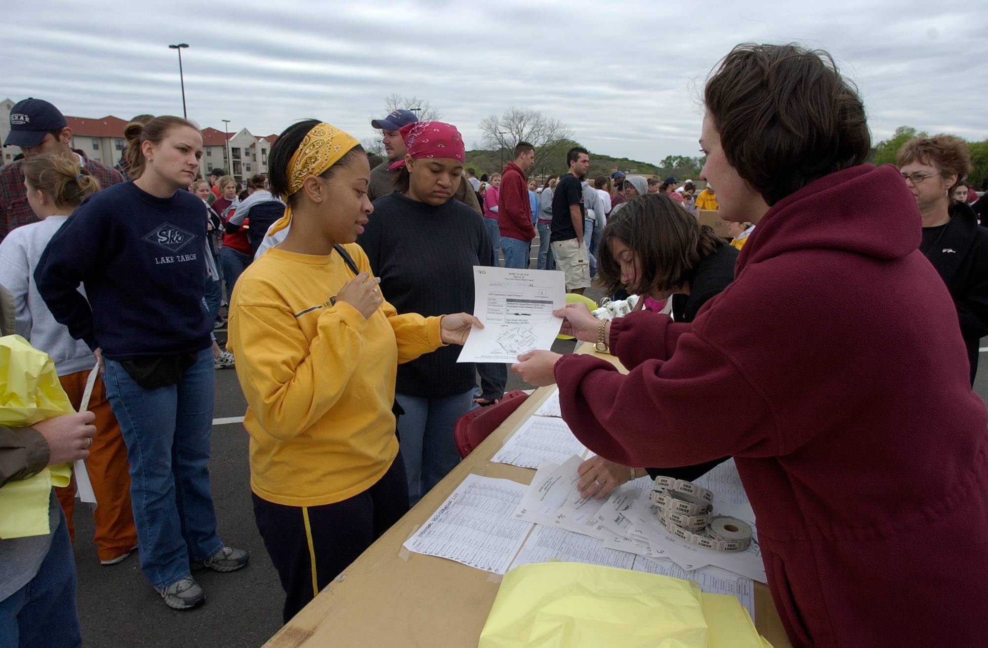 A volunteer receiving a paper with information about their assignment for Bobcat Build. 