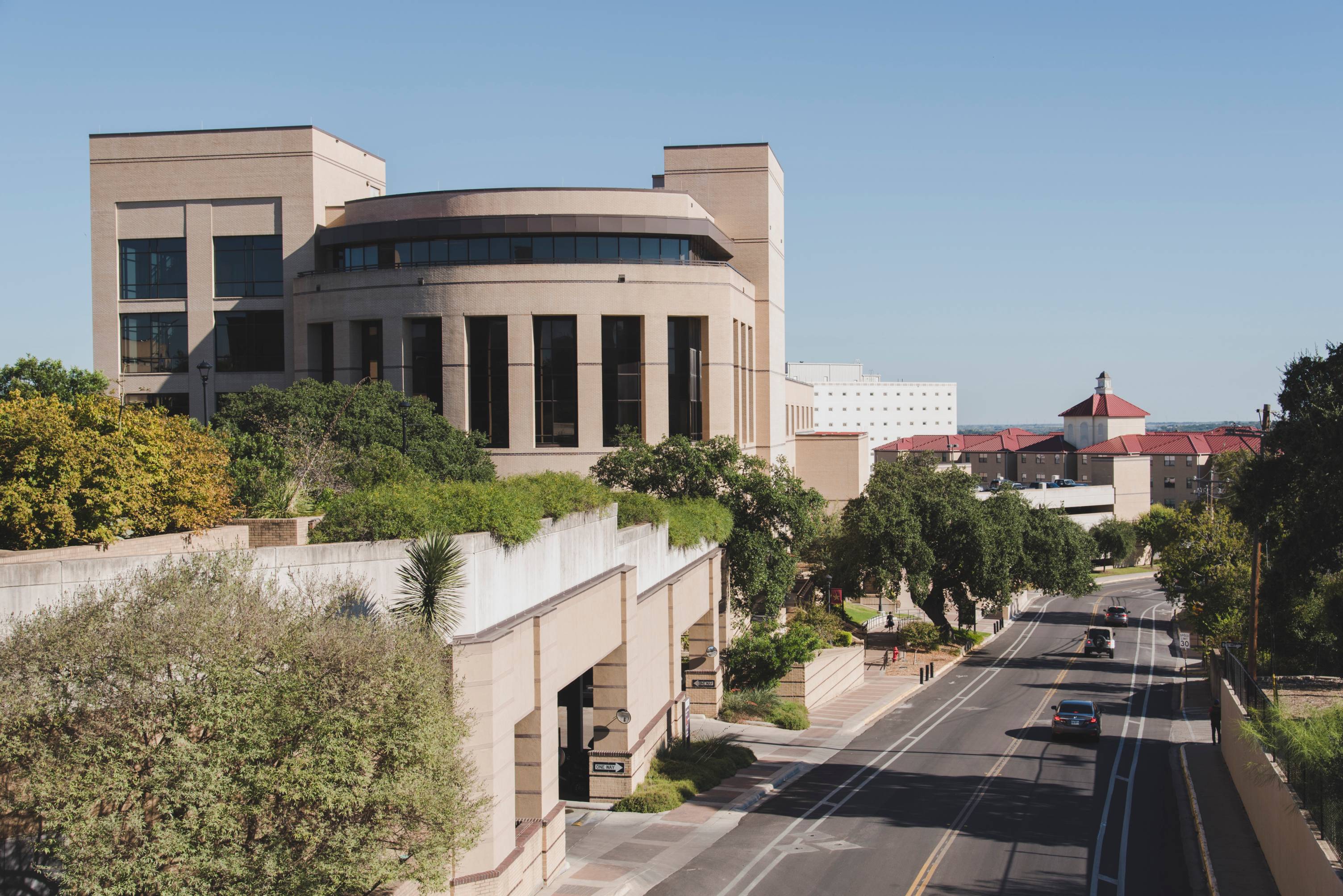 A view of McCoy Hall from the bridge above Comanche Street. 