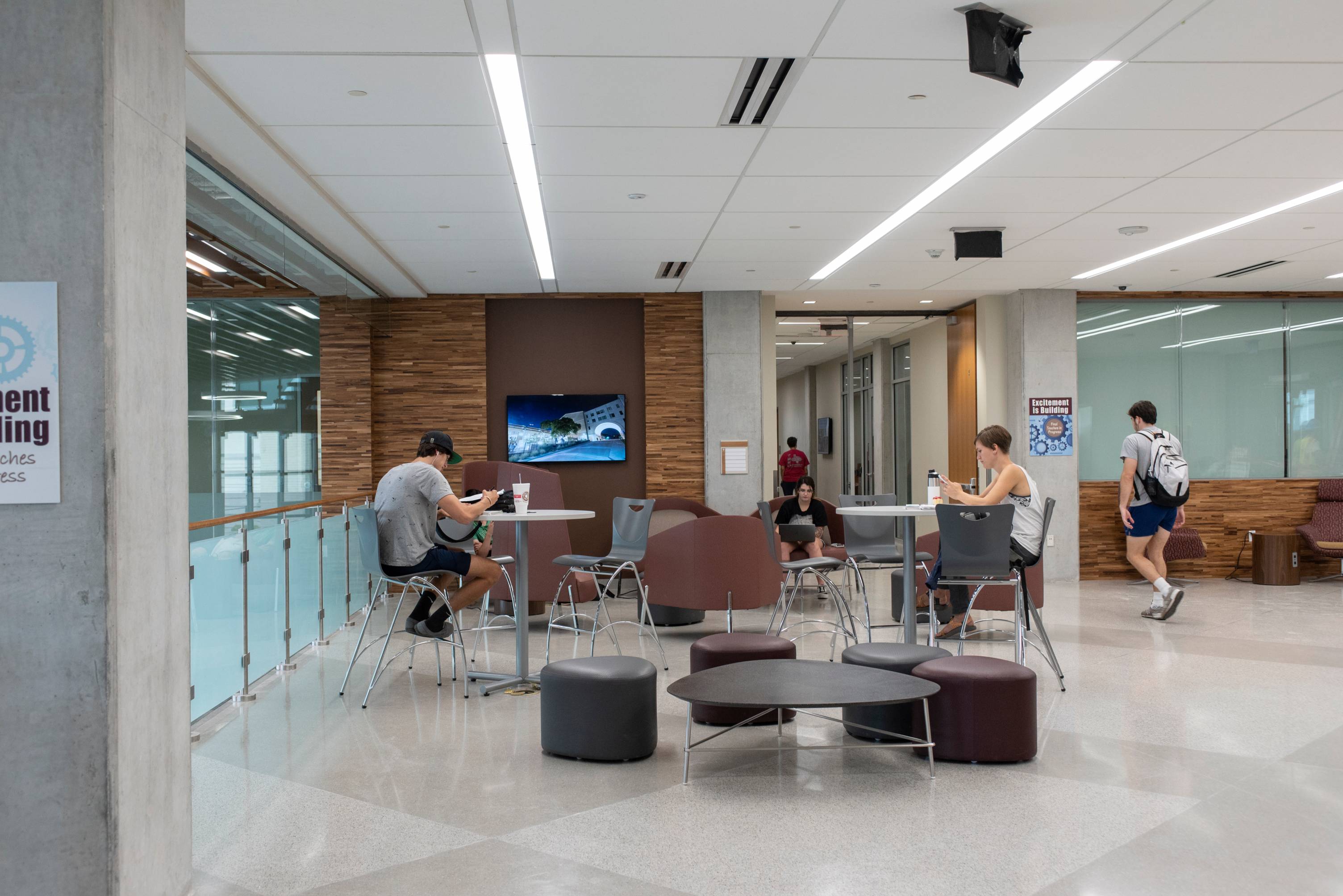 Students studying and walking between classes in one of Ingram's open concept study spaces on the third floor. 