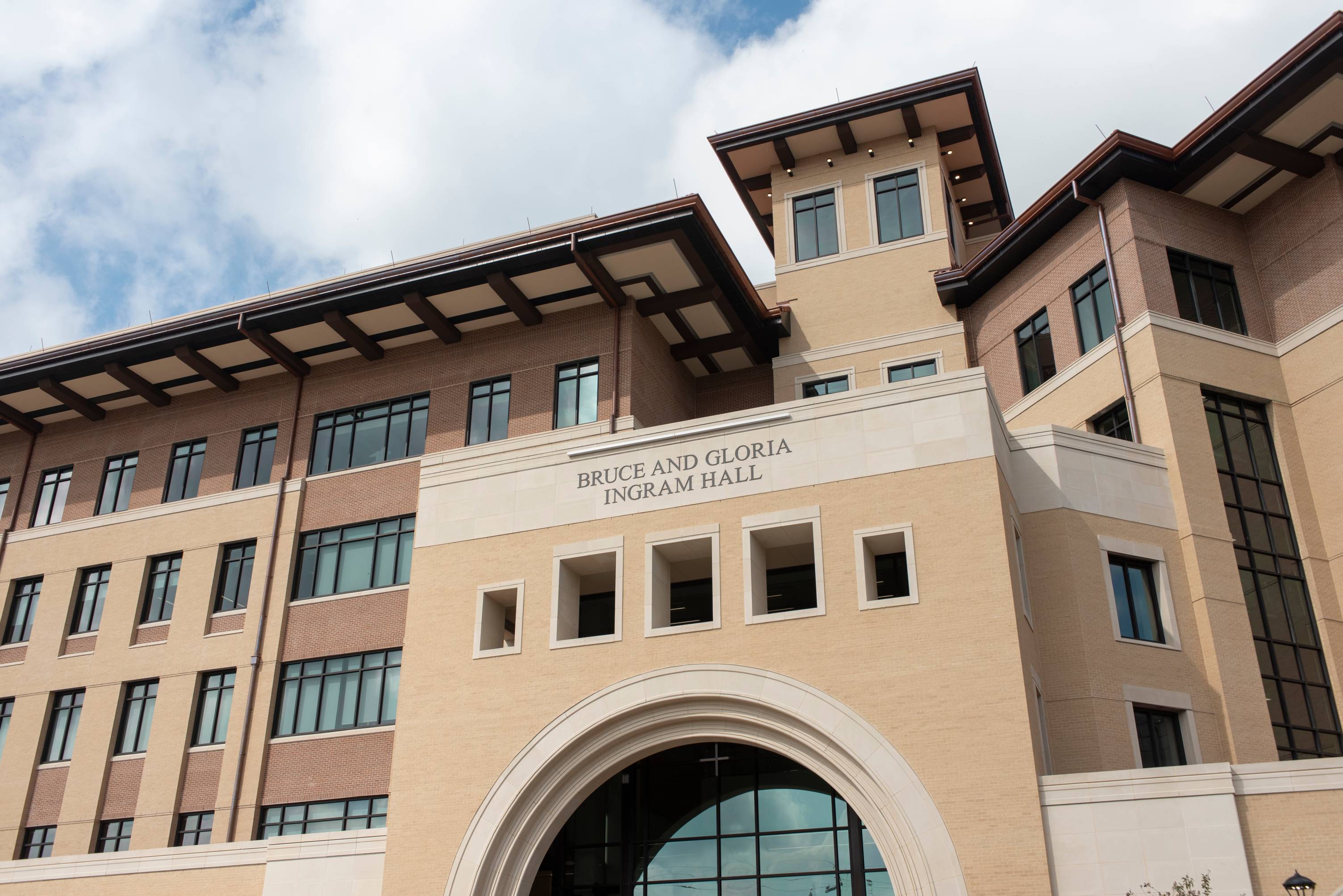 An upward angle view of the main entrance to Bruce and Gloria Ingram Hall. 