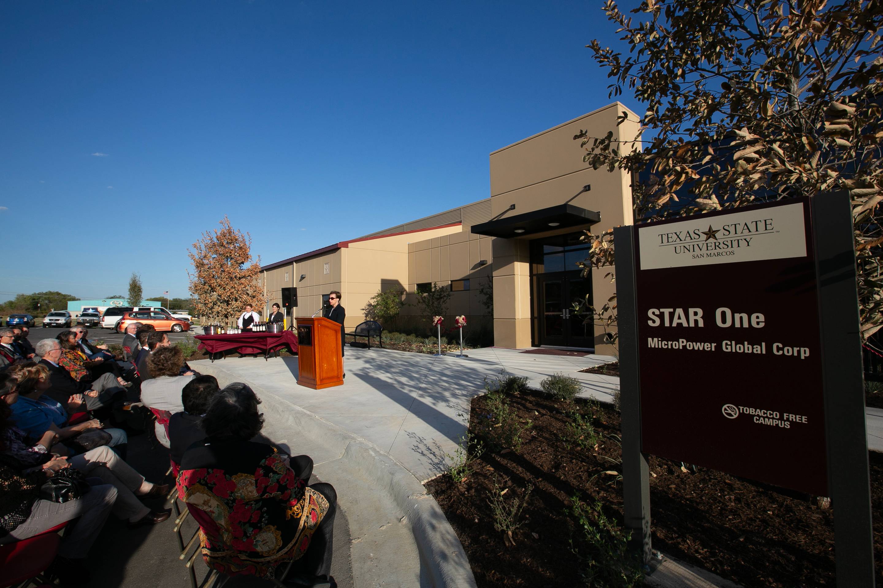 STAR Park's opening ceremony in front of the building, with a crowd listening to President Trauth speak. 