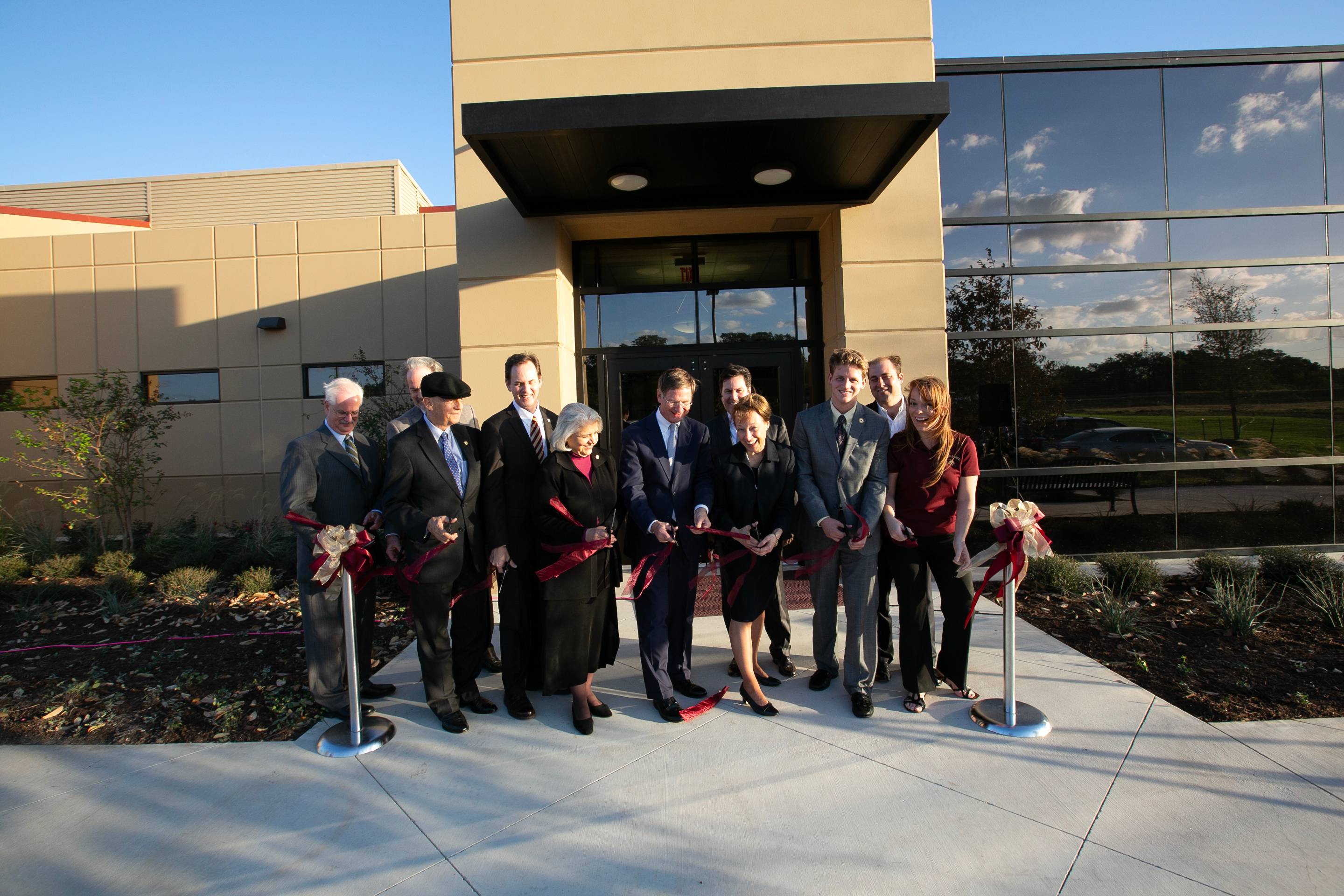 President Trauth cutting the ribbon at STAR Park's opening, surrounded by donors.