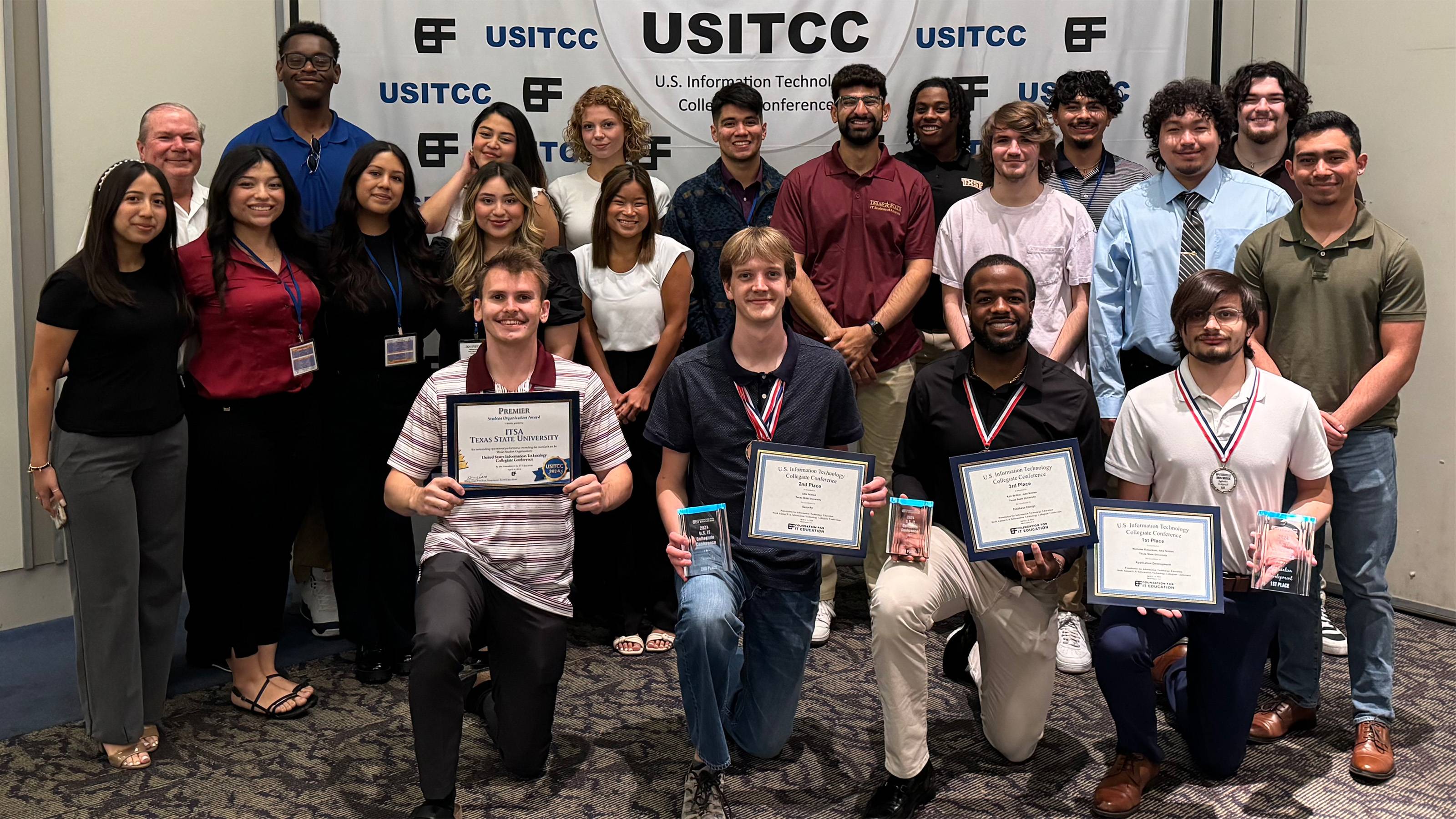 College students posing with awards at U.S.I.T.C.C. Conference