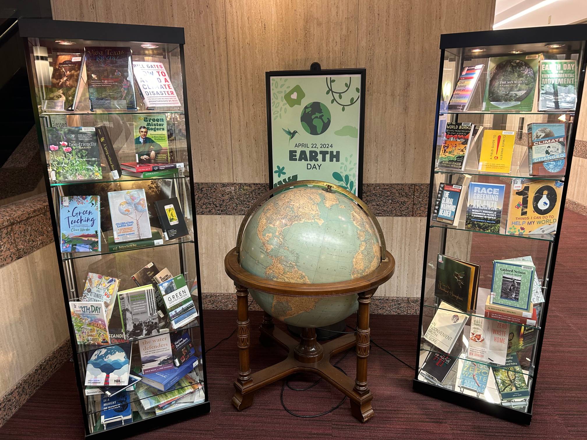 Glass case housing books about earth day