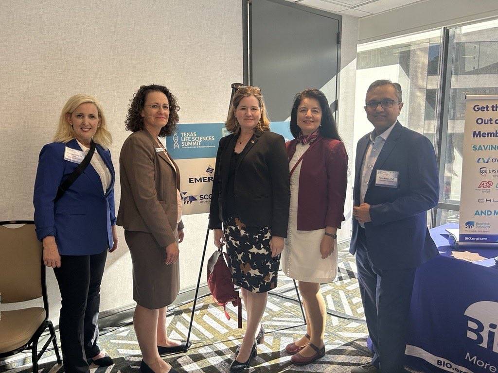 Melinda Villagran and others posing for a picture at the Texas Life Sciences Summit