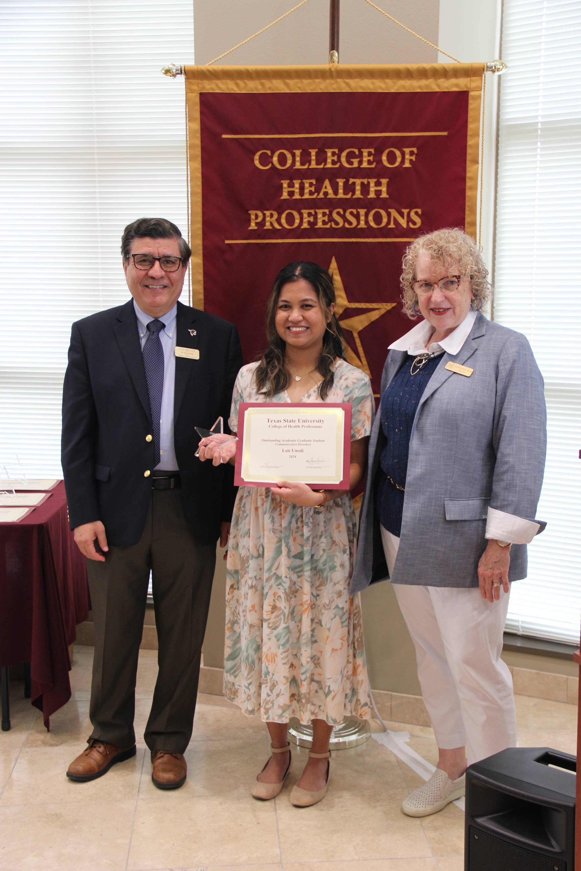 CDIS student Lois Umali receiving an award.