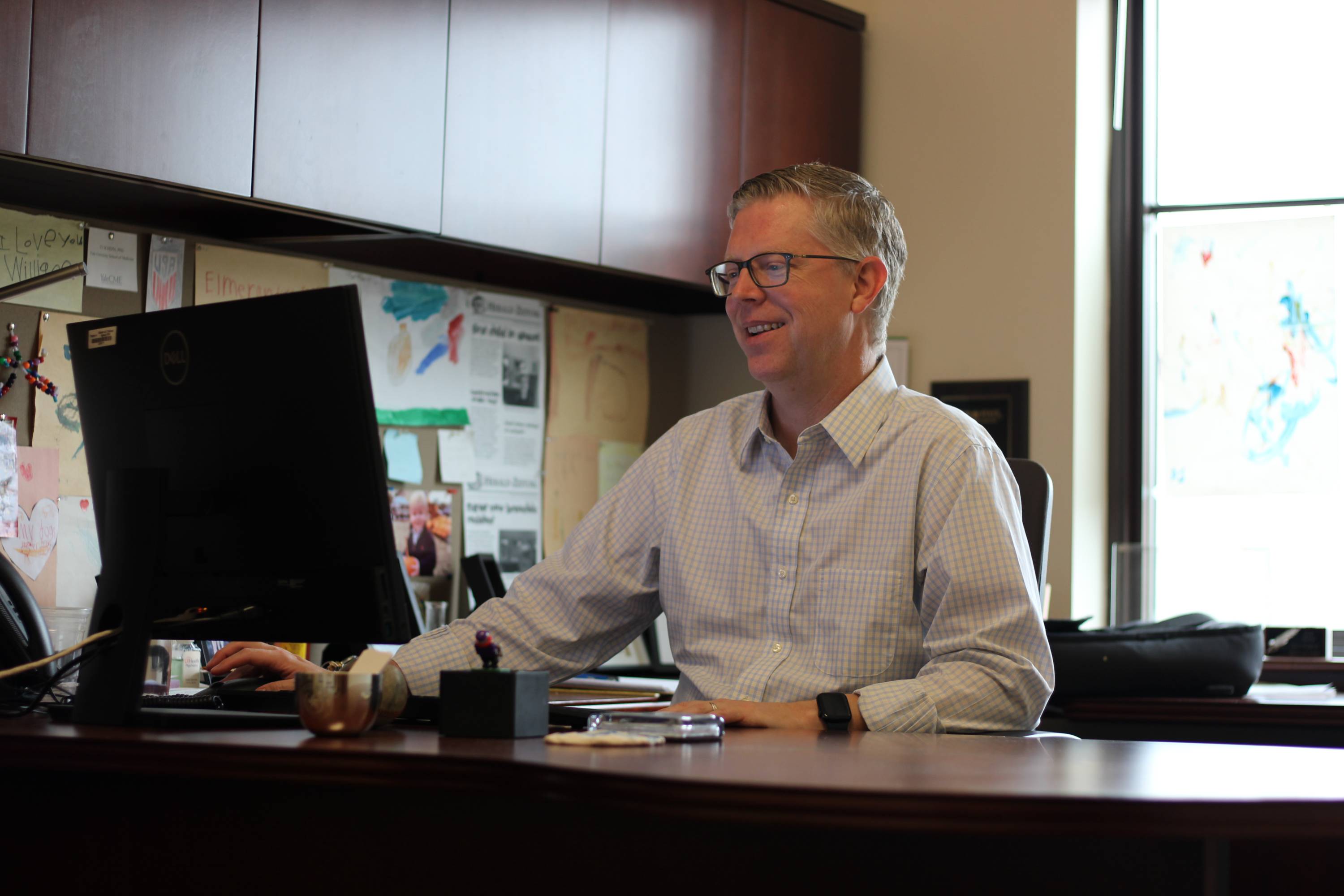Dr. Ty Schepis smiling while doing research in his office.