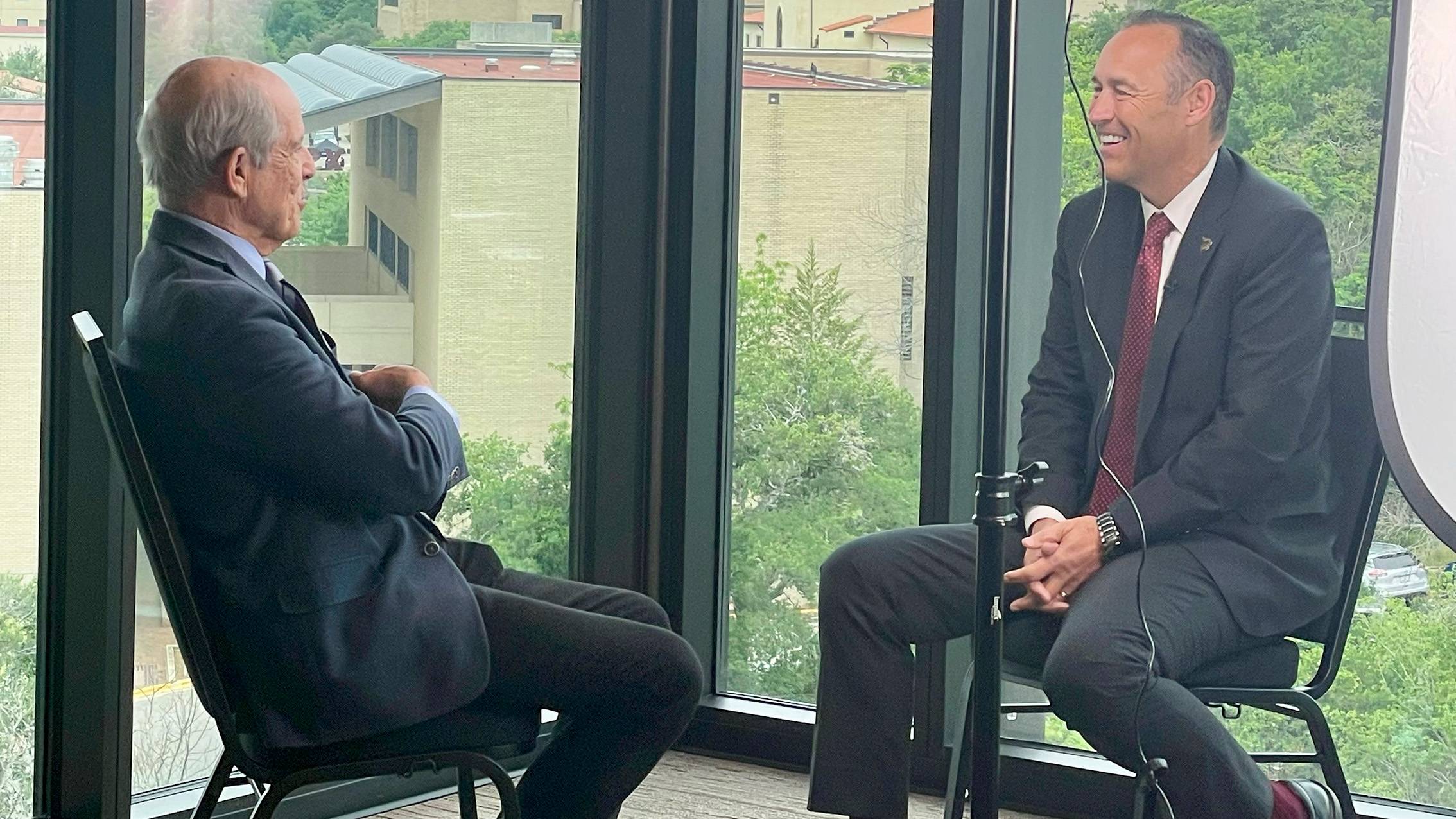 Paul Solman, left, interviews TXST President Kelly Damphousse.