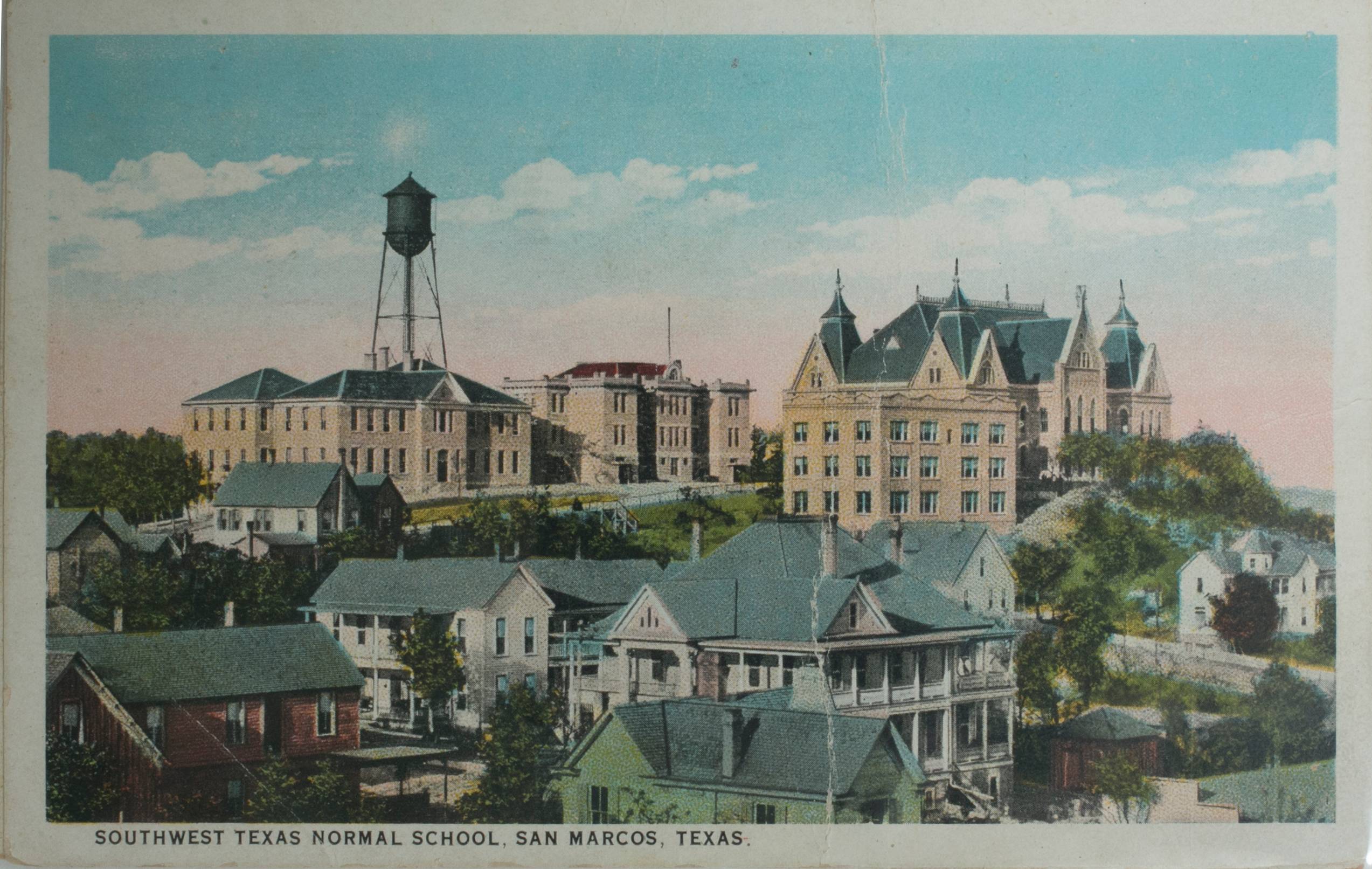 Vintage postcard featuring a colorized photograph of the Southwest Texas Normal School's campus. Several grand, wooden houses with large wrap-around porches crowd the hill. Uphill, the iconic Old Main Building towers alongside other imposing brick structures. In the background, a dark water tower soars above the rooftops.