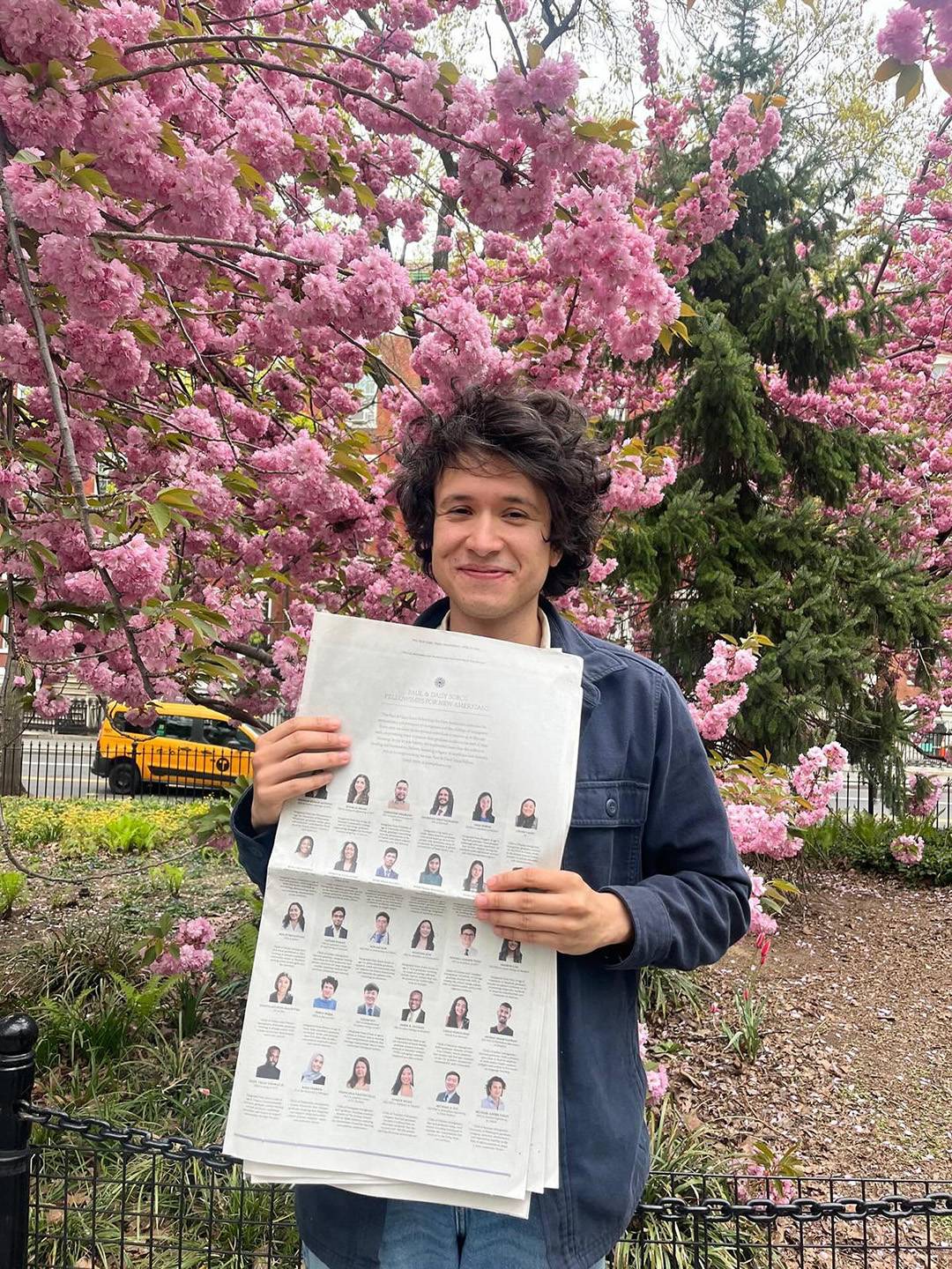 Pablo Mejia holds a copy of The New York Times featuring the newly announced Paul & Daisy Soros Fellows.