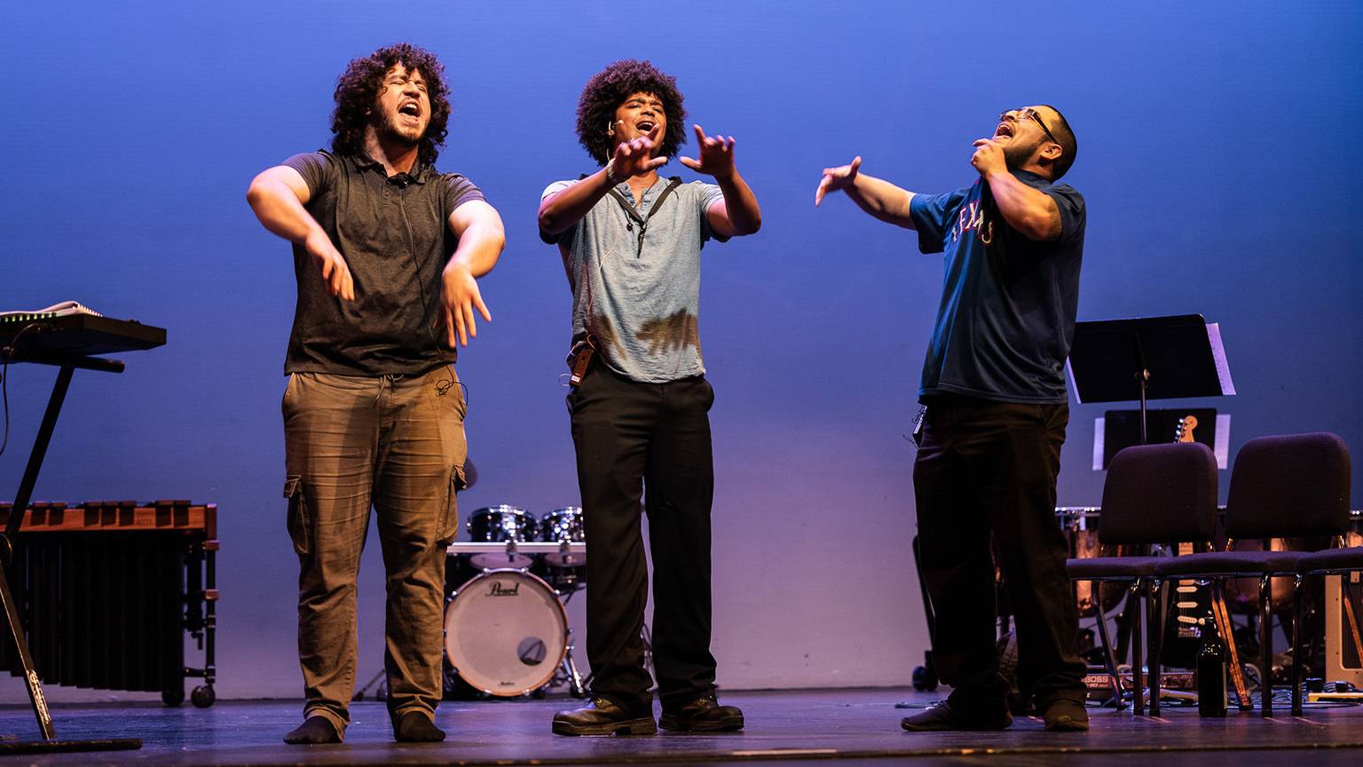Jay Nava, left, performs on stage during his hip-hop opera with two other performers.