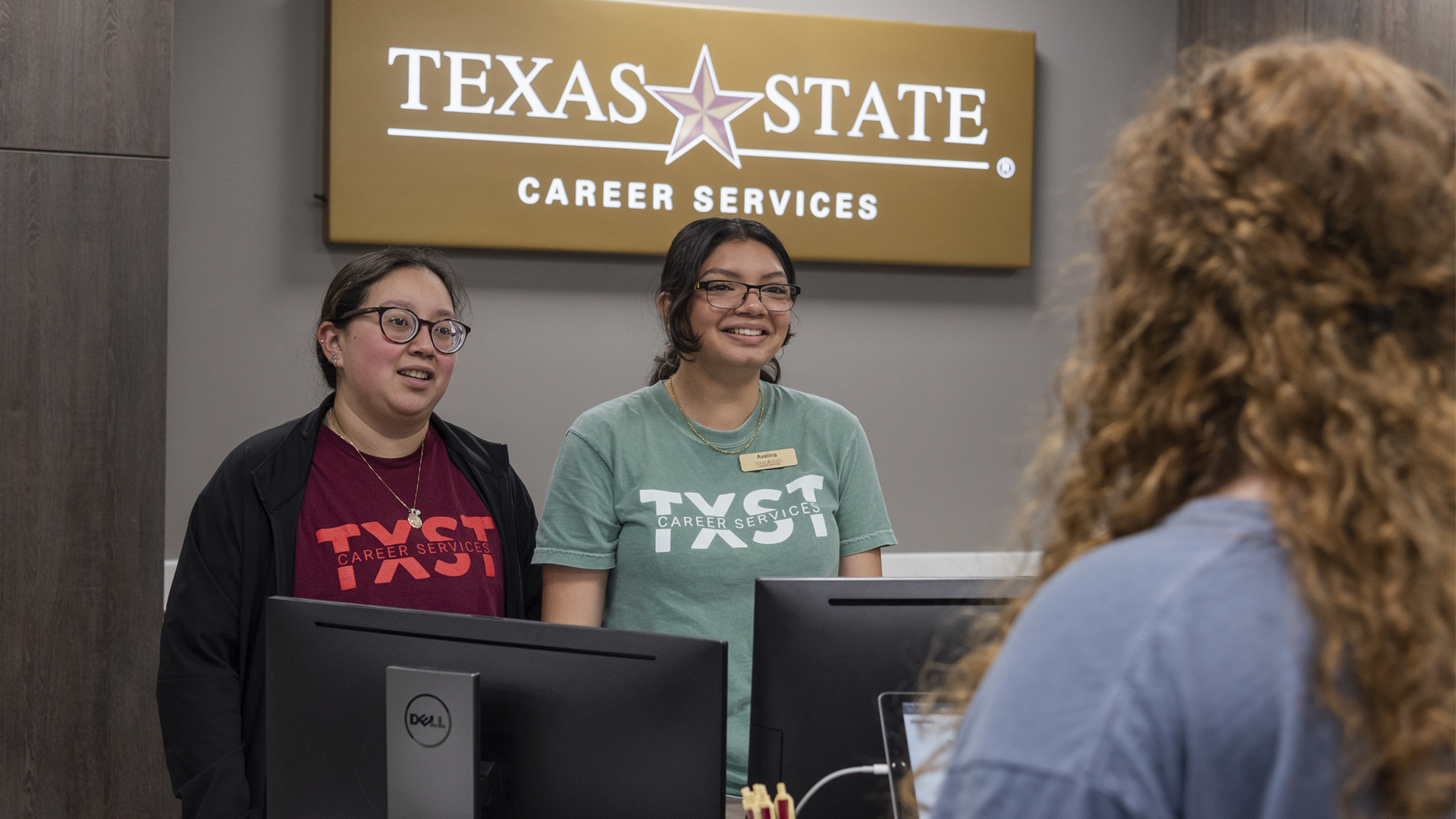 Two women smiling at the career services desk