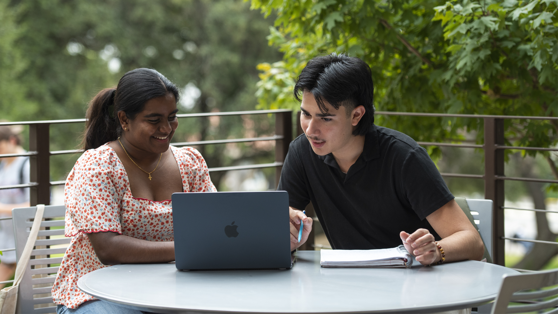 two people sitting looking at a computer