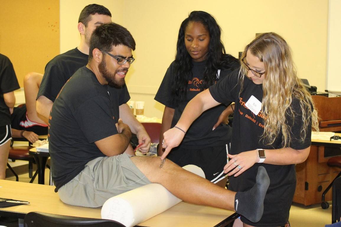 atheltic training students testing knee reactions