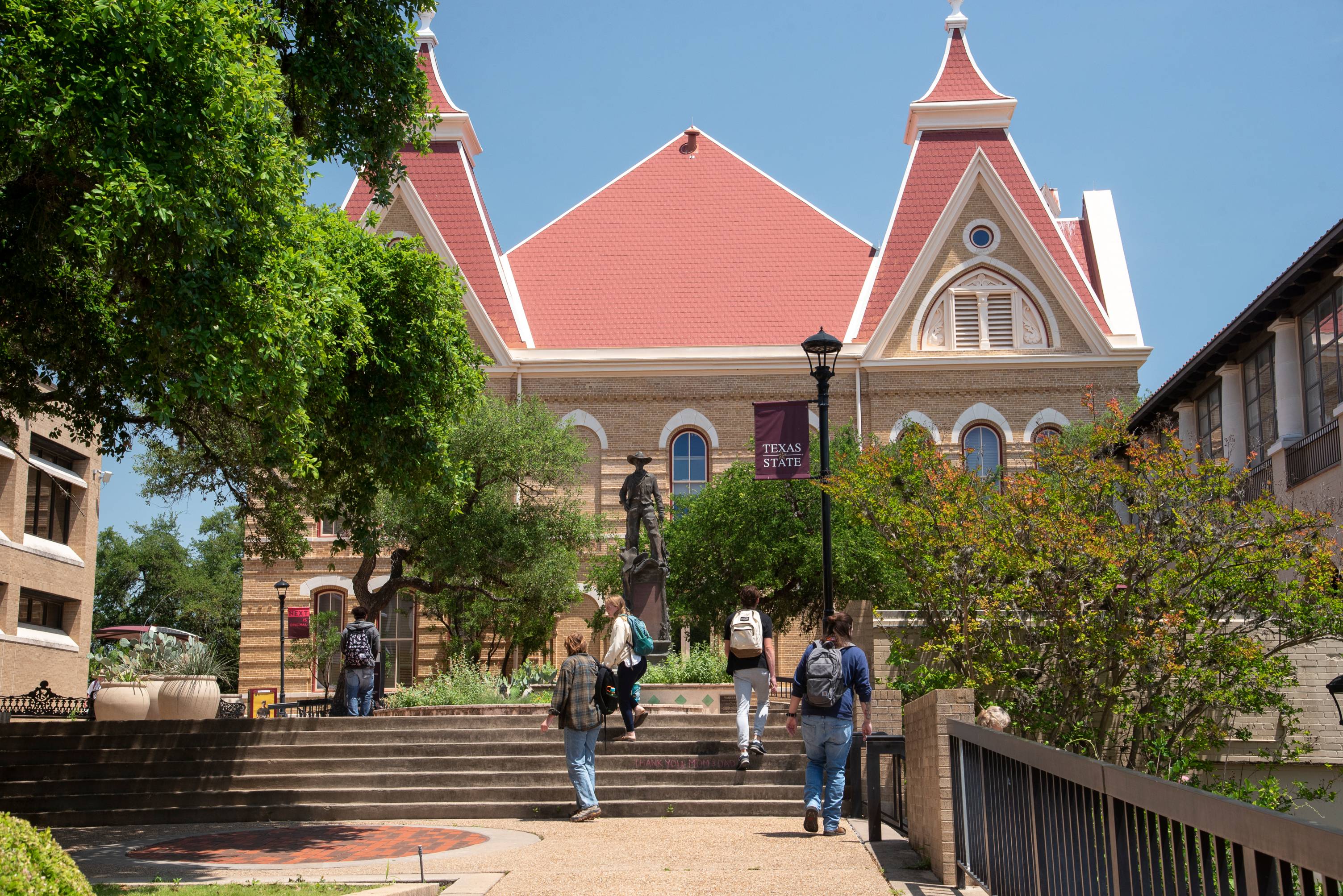 students walking up stairs on a college campus