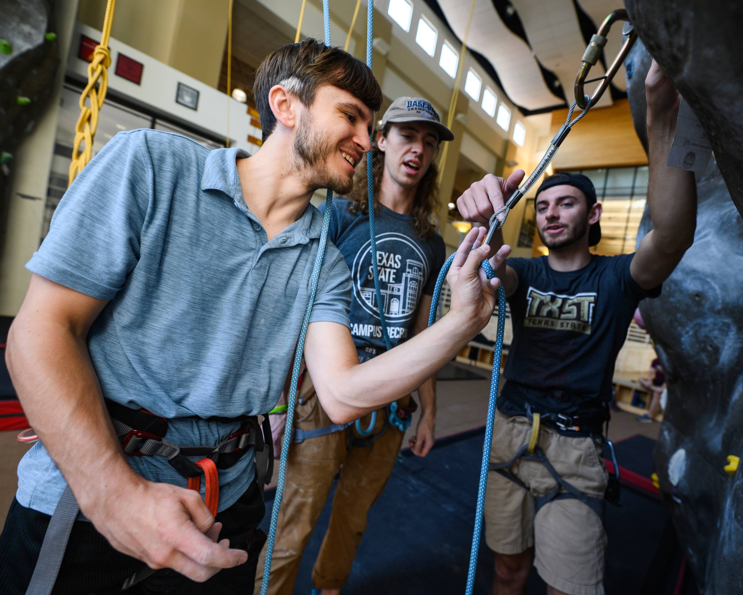 three climbers learning how to lead clip