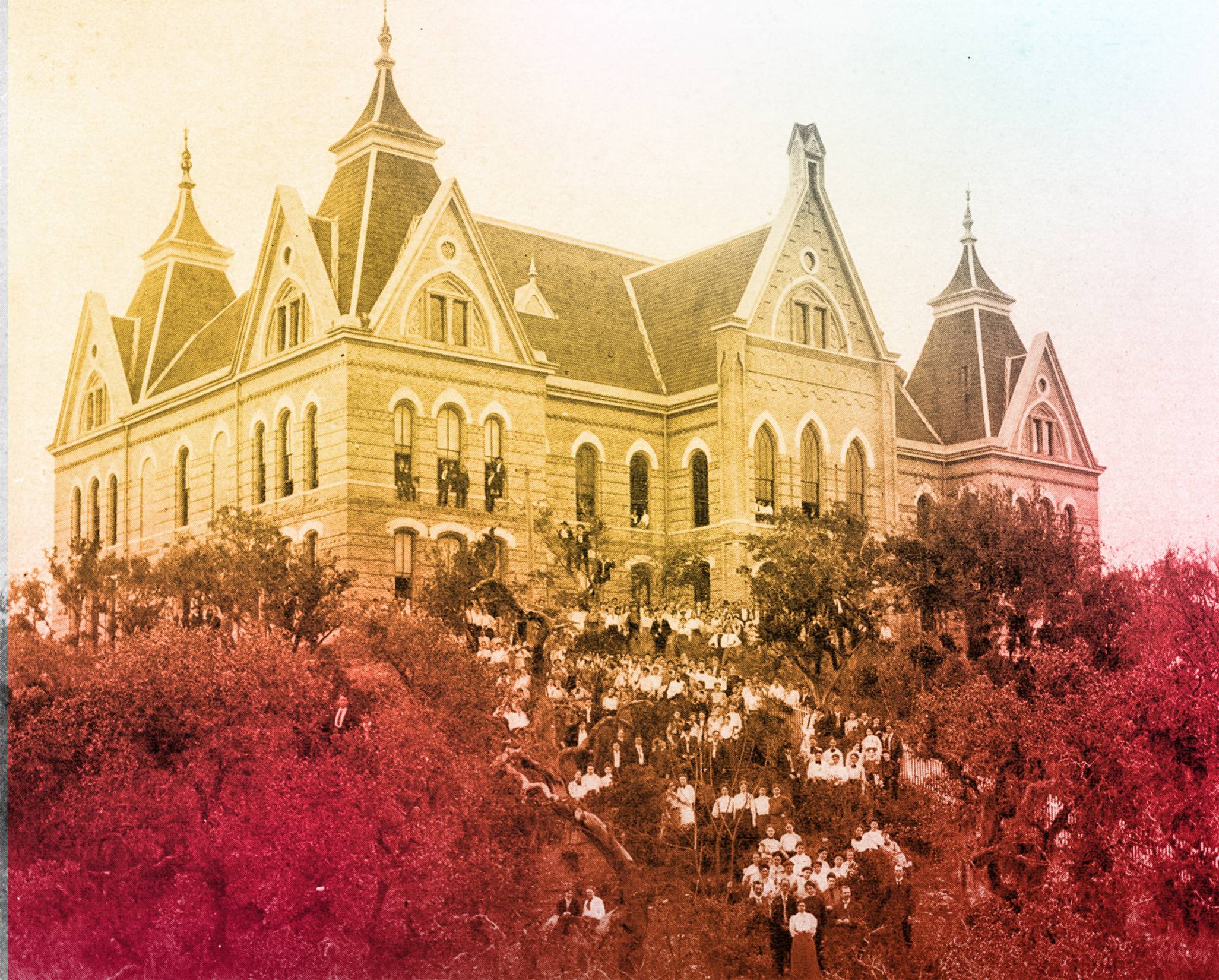 an aged black and white photo of a large building on a hill with students standing on the hill with a colorful gradient overlay