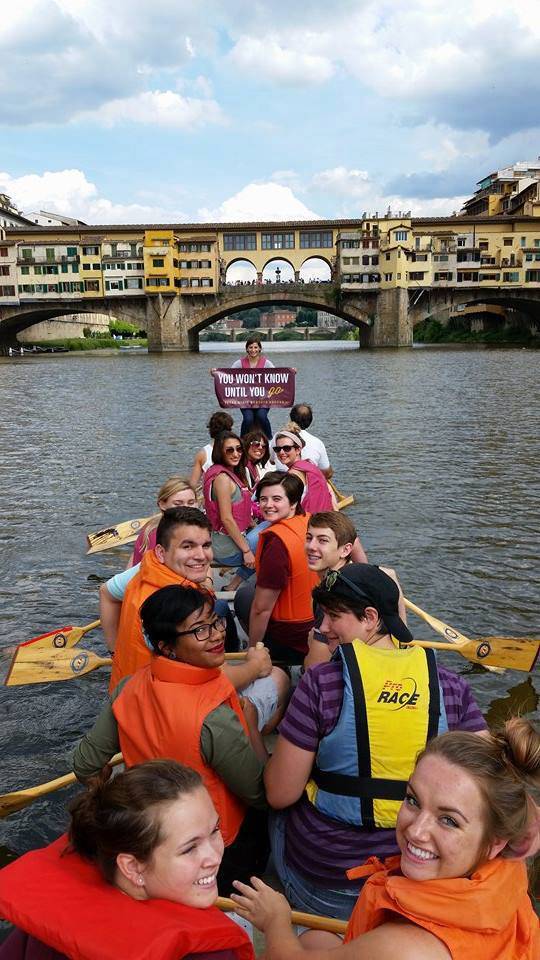 A group of TXST students pose for a photo while kayaking down a river in Italy.