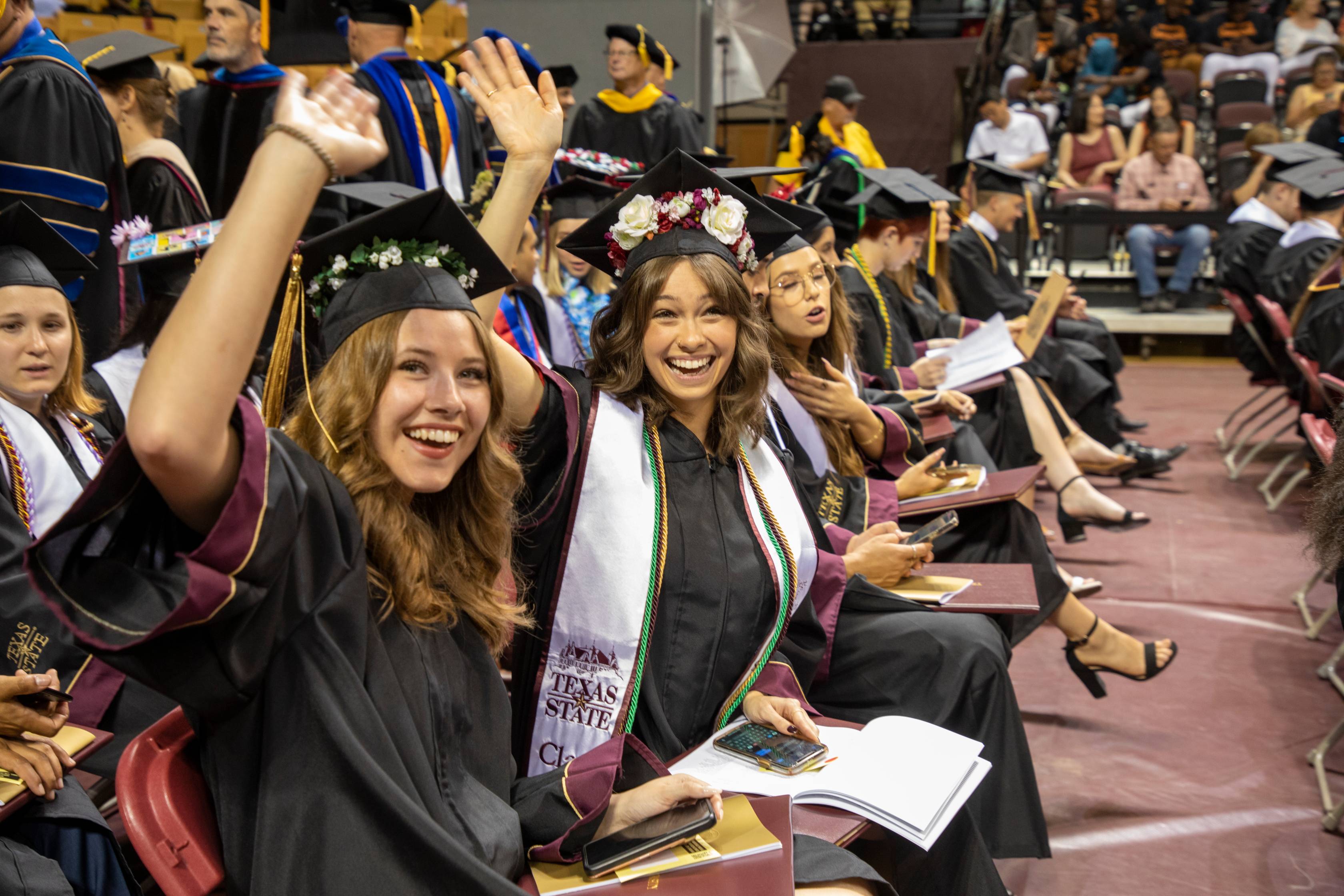 3 female students at graduation, smiling