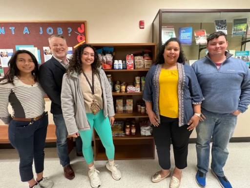 COE Faculty, Staff and Students in front of cupboard