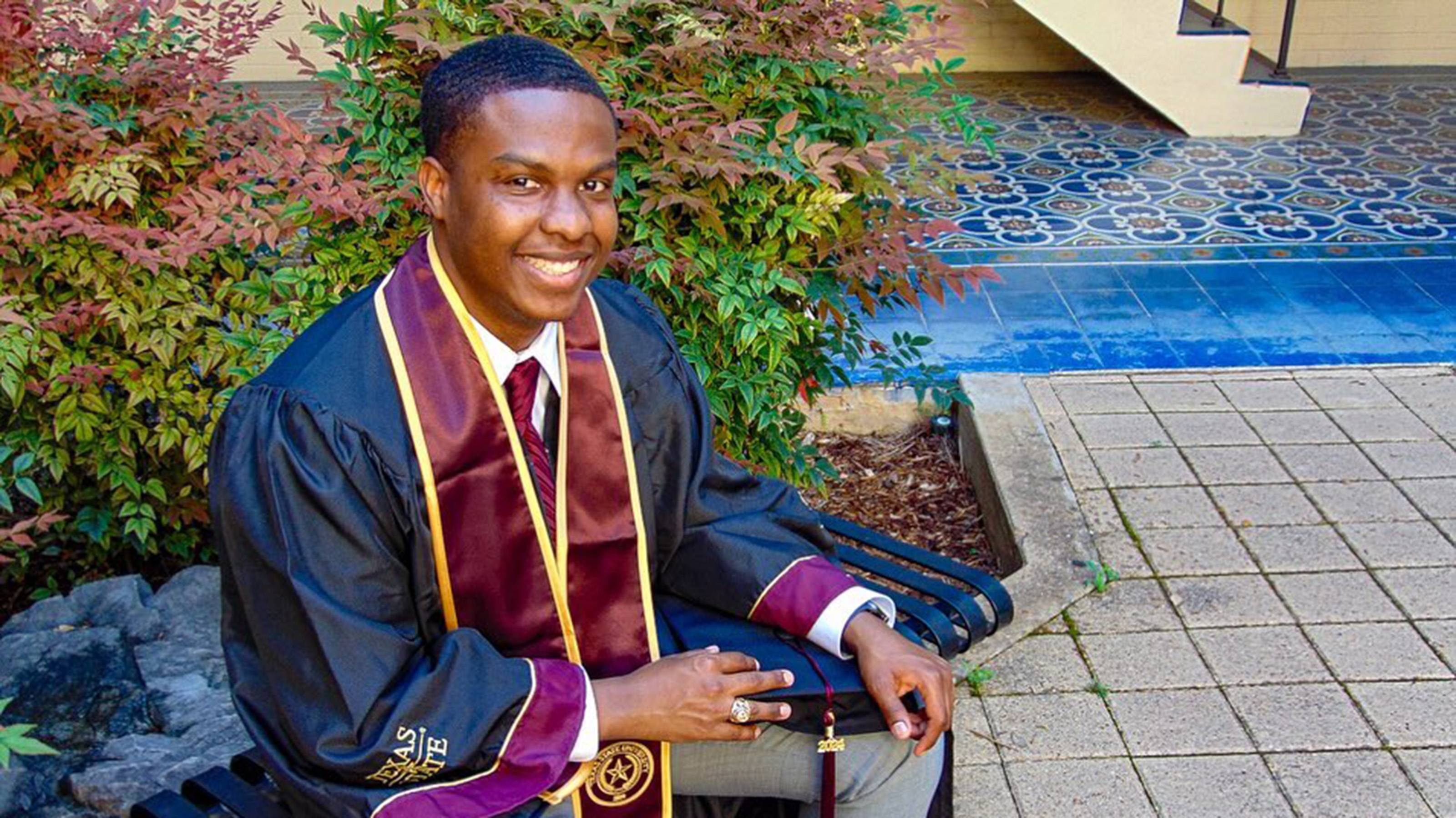 Jalen Wright seated in graduation regalia