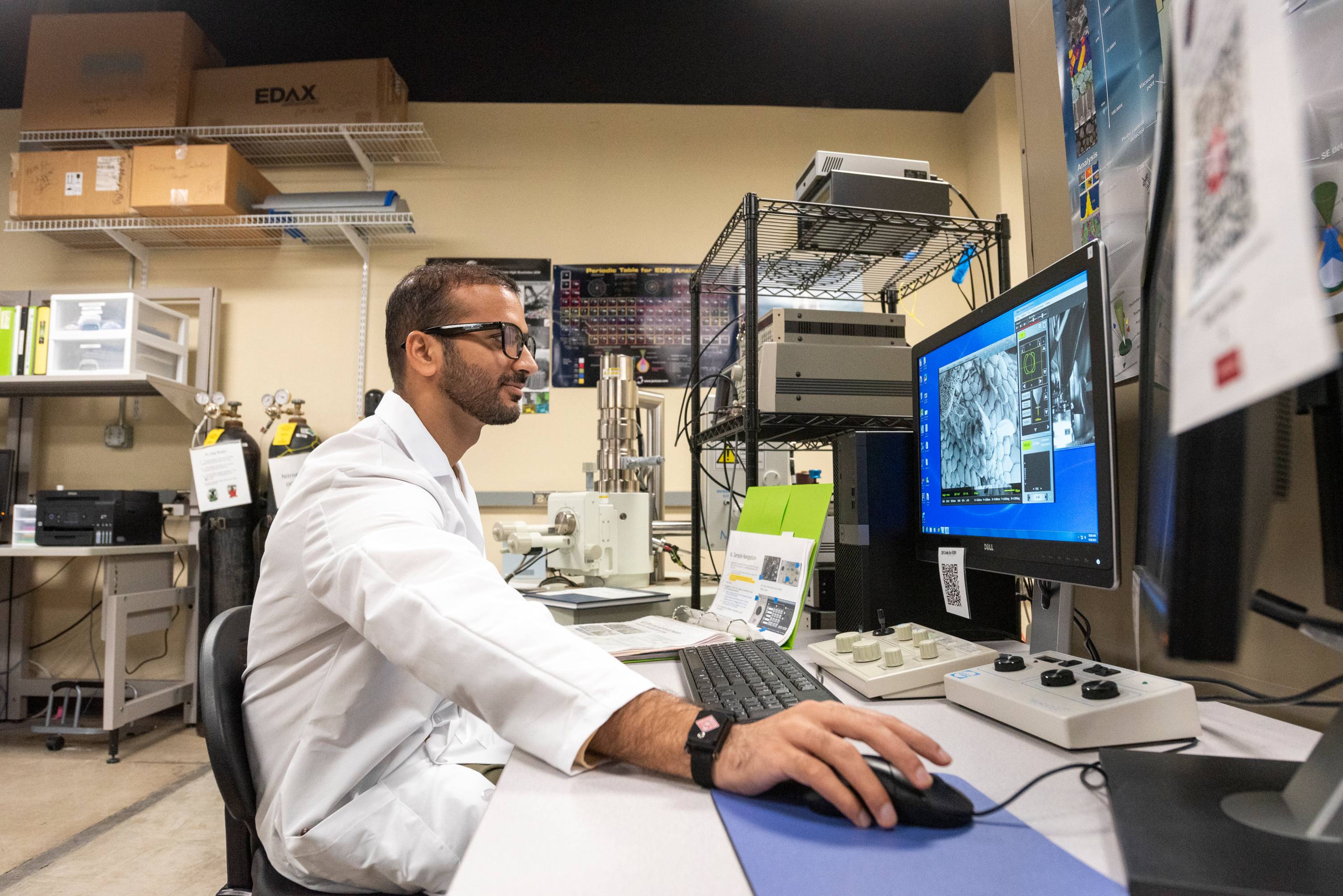 a science researcher working at a computer desk