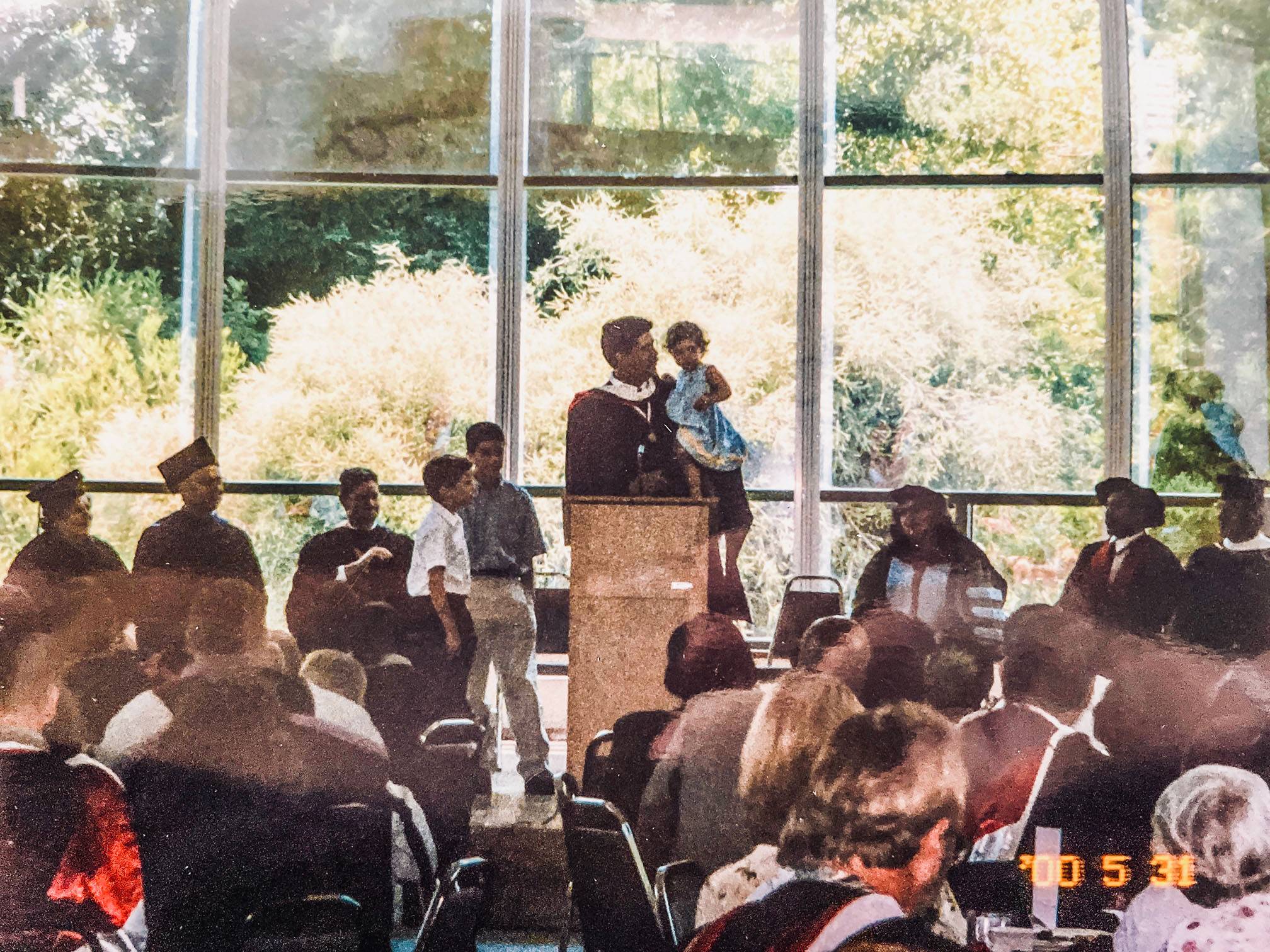 Kevin holds his daughter, Anna Marie, who was less than a year and a half old at the time, as he gave his summa cum laude speech at California State University’s commencement ceremony in 2000.